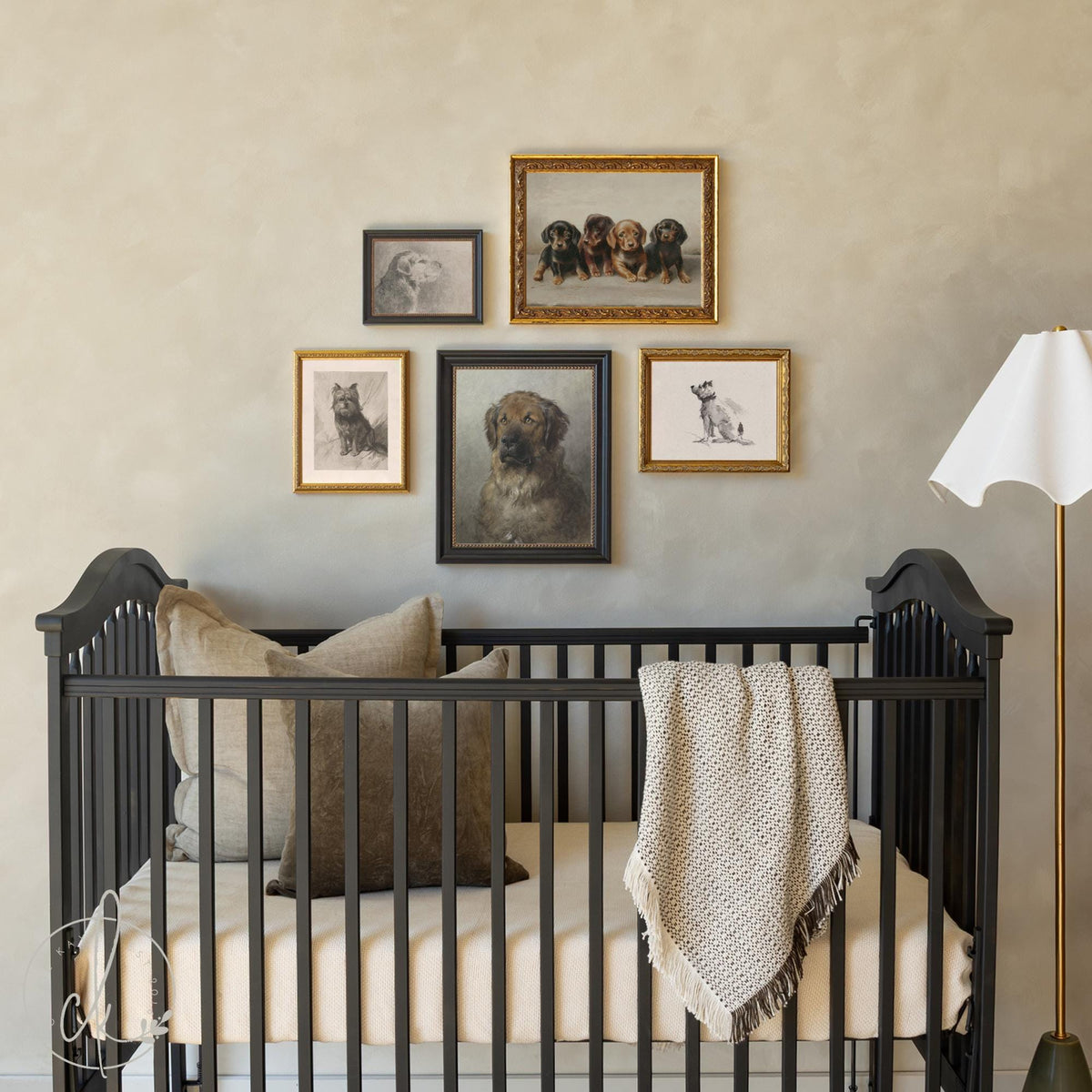 Dog gallery wall featuring vintage framed dog art set above a nursery crib.