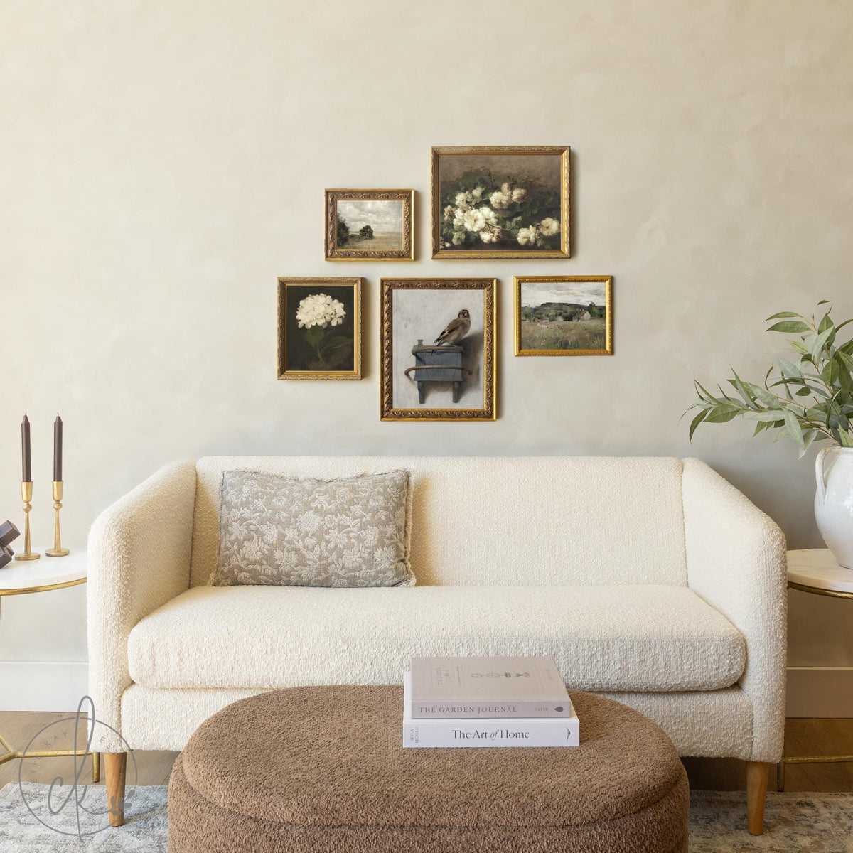 Gold frame gallery wall set with vintage floral and landscape art in ornate gold frames above sofa.