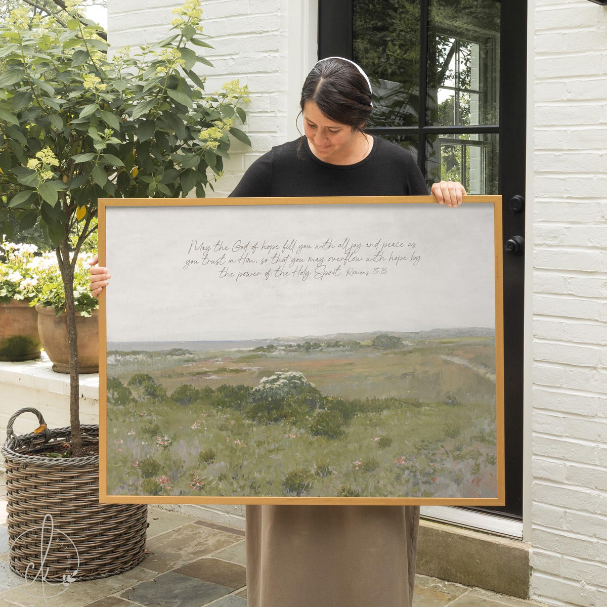 Scripture wall decor with Romans 15:13 verse on framed meadow landscape canvas.