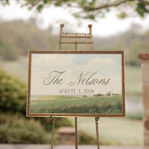 Wedding welcome sign with vintage green meadow landscape and personalized last name in gold frame
