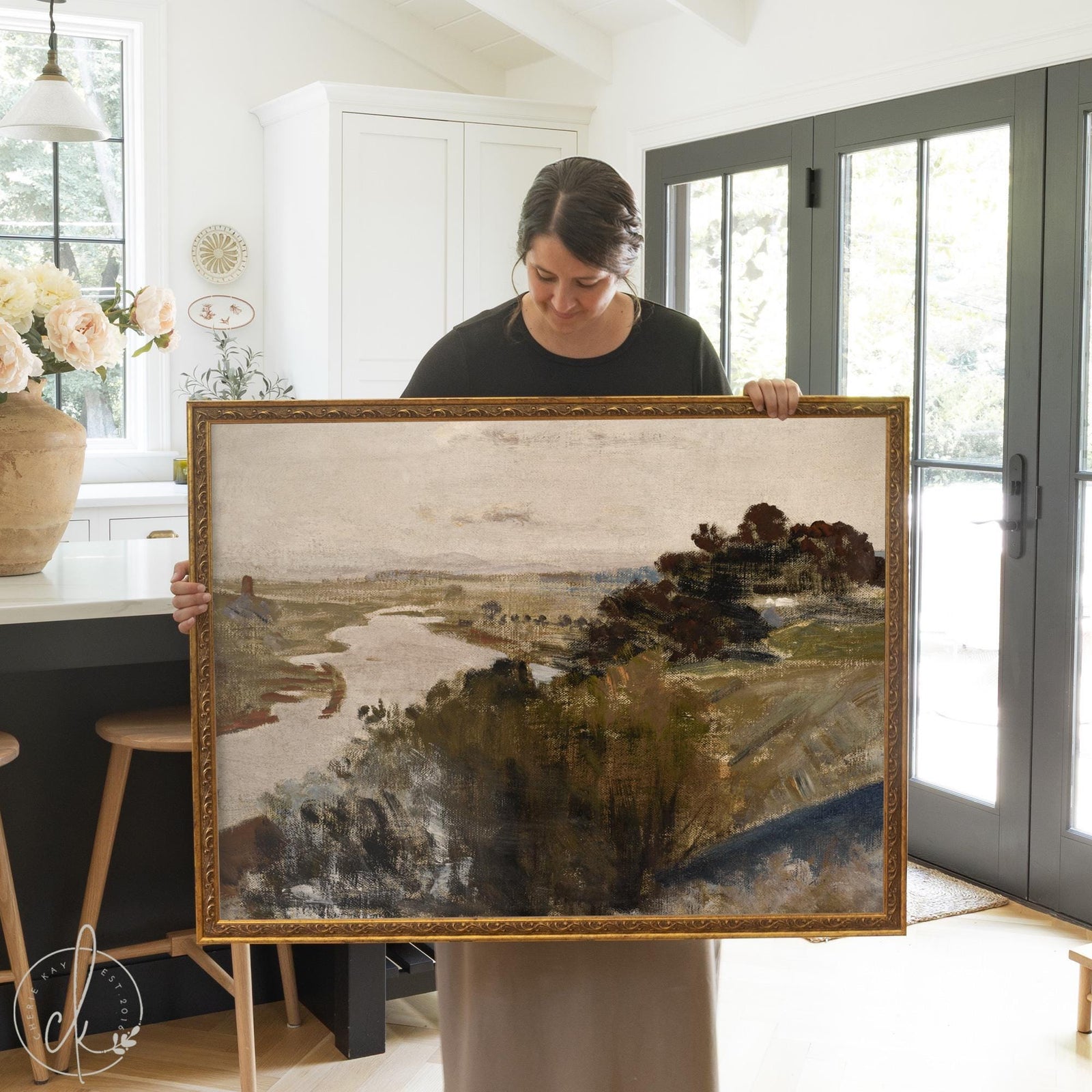 Vintage landscape painting of a river valley with trees in an ornate gold frame