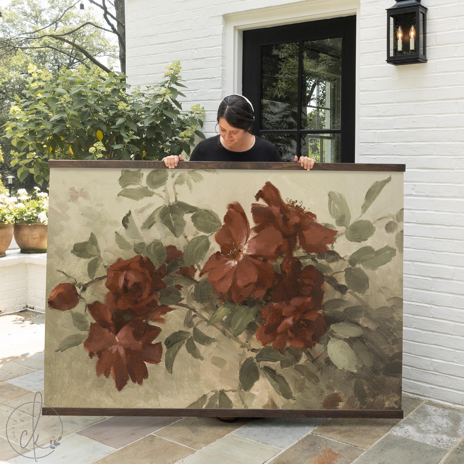 Dark floral wall art canvas tapestry with deep burgundy flowers and sage green leaves on a canvas background in wood frame.