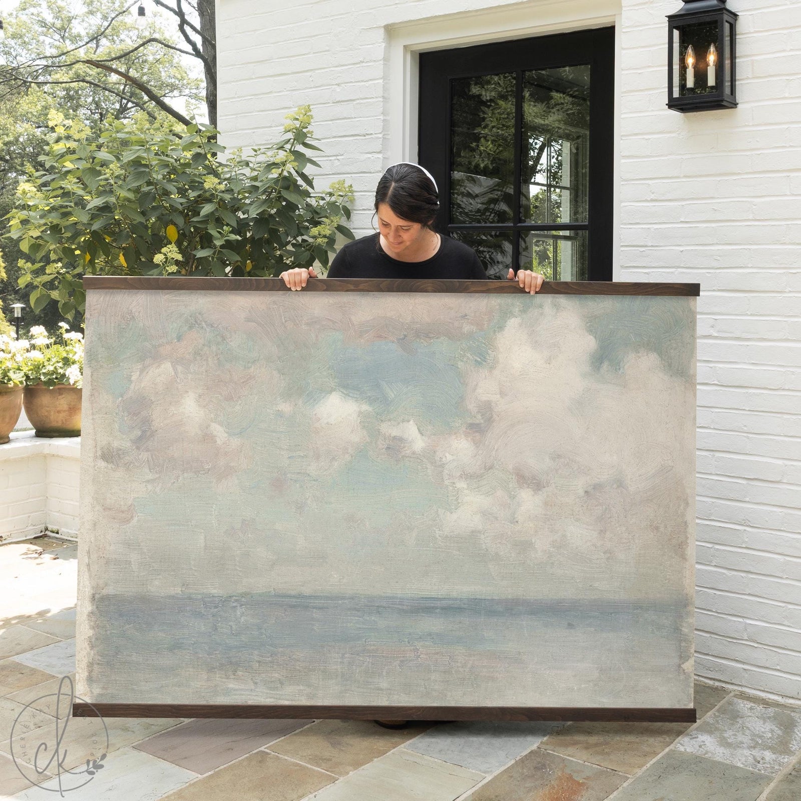 Cloudy sky painting canvas tapestry with muted blue ocean horizon and white clouds in natural wood frame