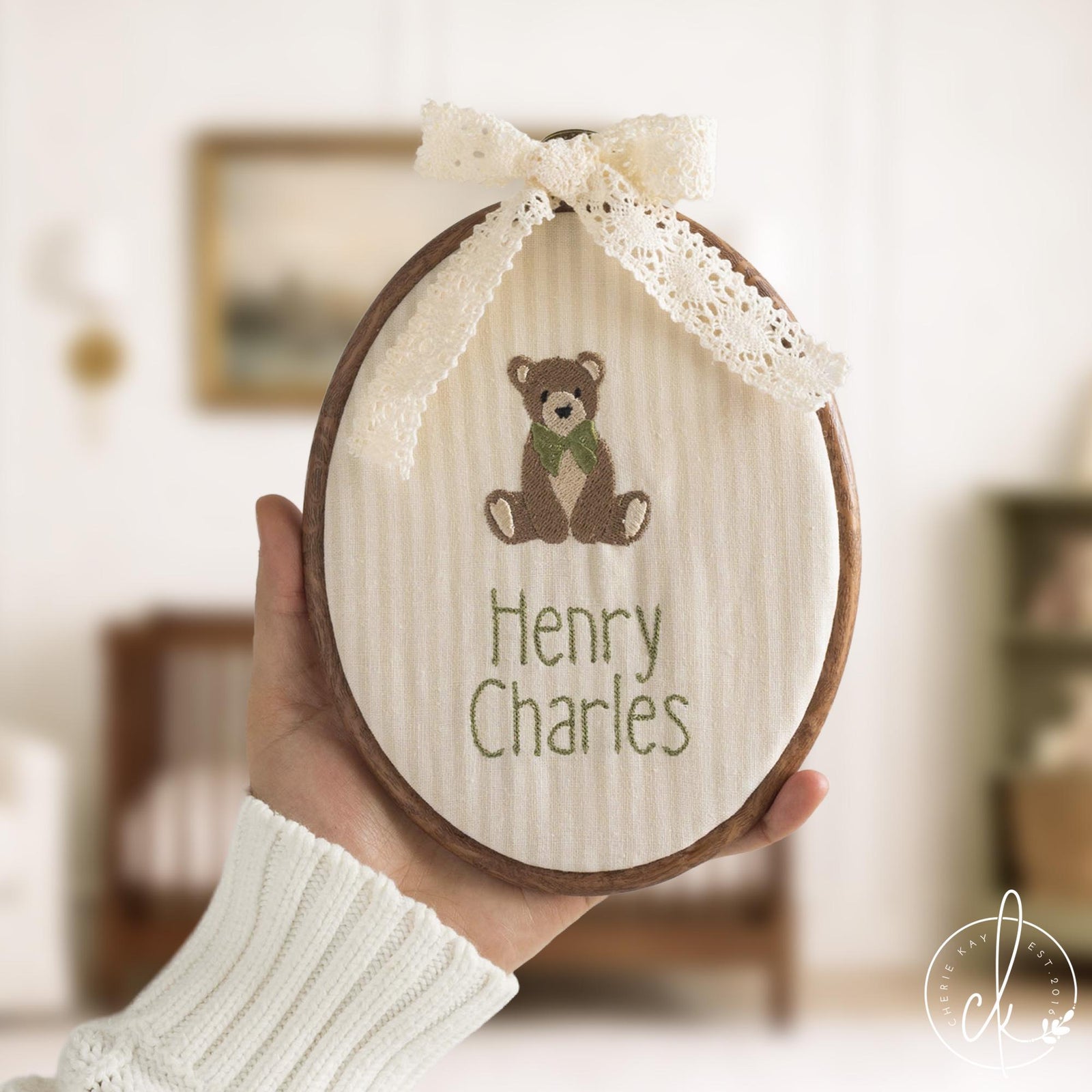 Teddy bear embroidery hoop art with personalized baby name and lace bow on cream striped fabric