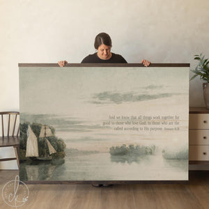 Sailboat canvas art with vintage watercolor sailboat on a misty lake and Romans 8:28, finished in a natural wood frame.