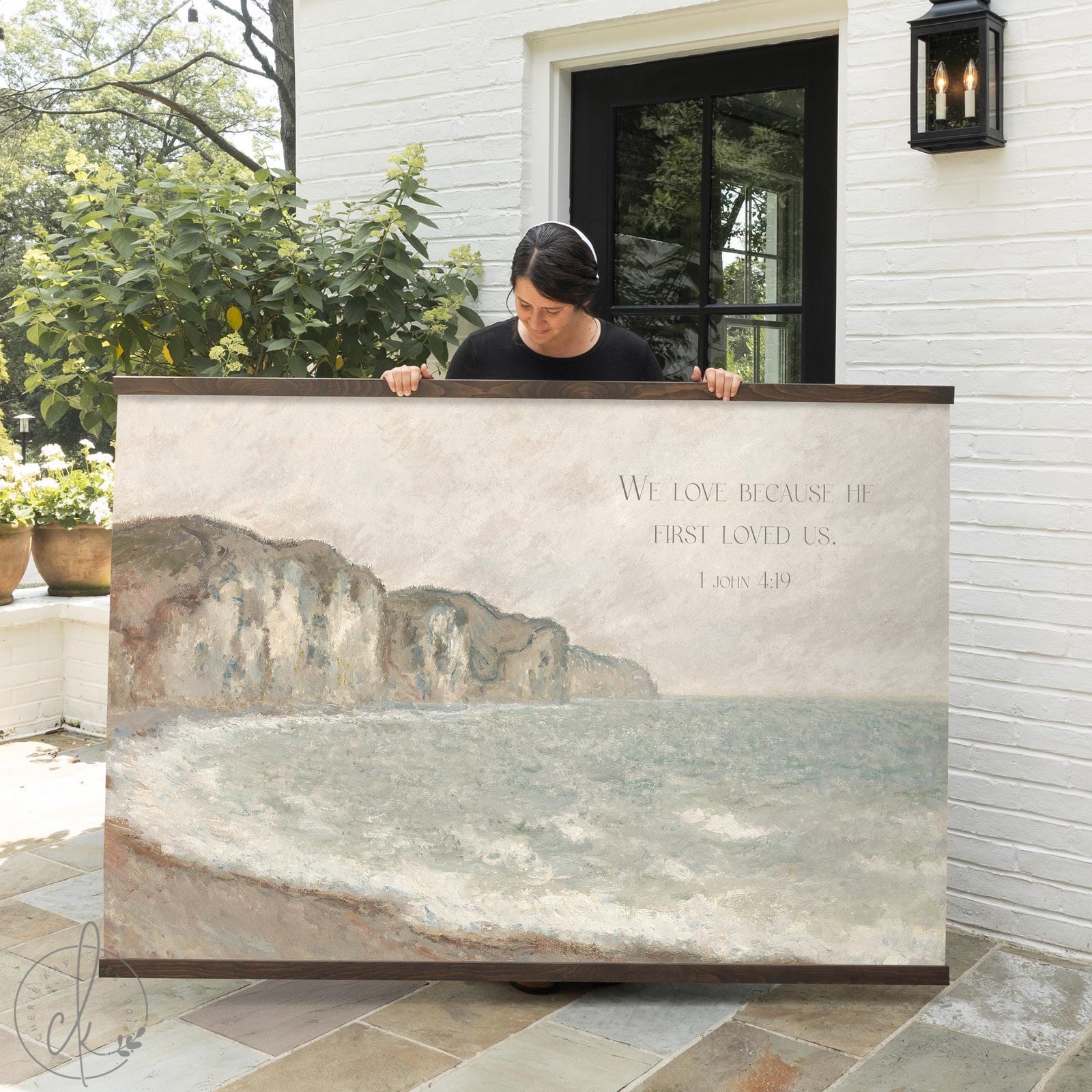 Claude Monet seascape canvas tapestry of Falaise De Pourville with 1 John 4:19 scripture in a natural wood frame