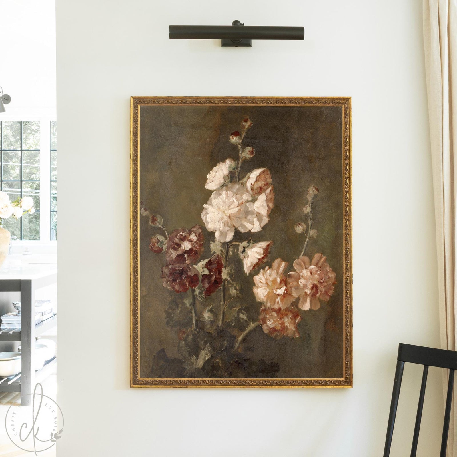 Moody floral wall art of hollyhocks in cream, burgundy, and soft peach in an ornate gold wood frame on a cream wall.