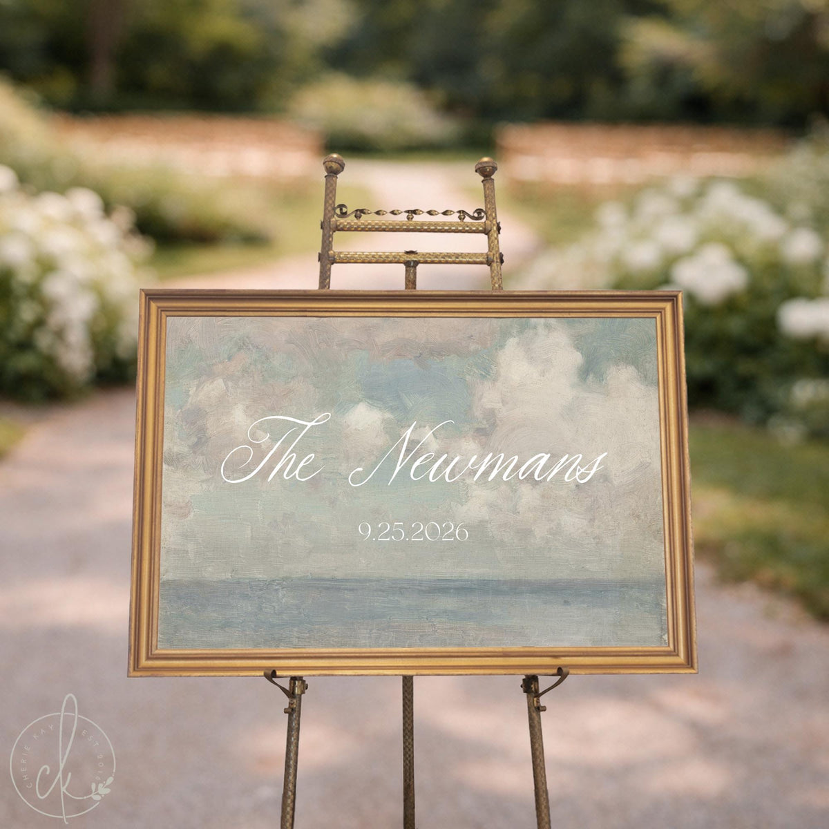 Coastal wedding decor canvas with personalized last name in white script over a soft painted seascape, in a gold wood frame.