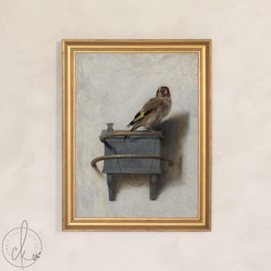 Vintage bird art: framed canvas print of a goldfinch perched on a small wooden feeder box, gold frame.