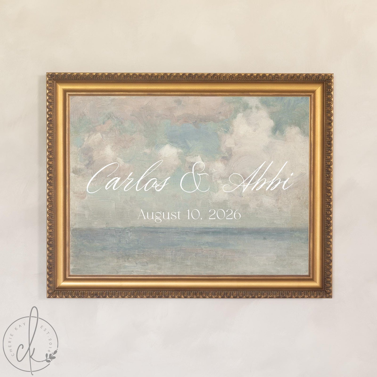 Coastal wedding decor canvas with personalized last name in white script over a soft painted seascape, in a gold wood frame.