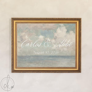 Coastal wedding decor canvas with personalized last name in white script over a soft painted seascape, in a gold wood frame.
