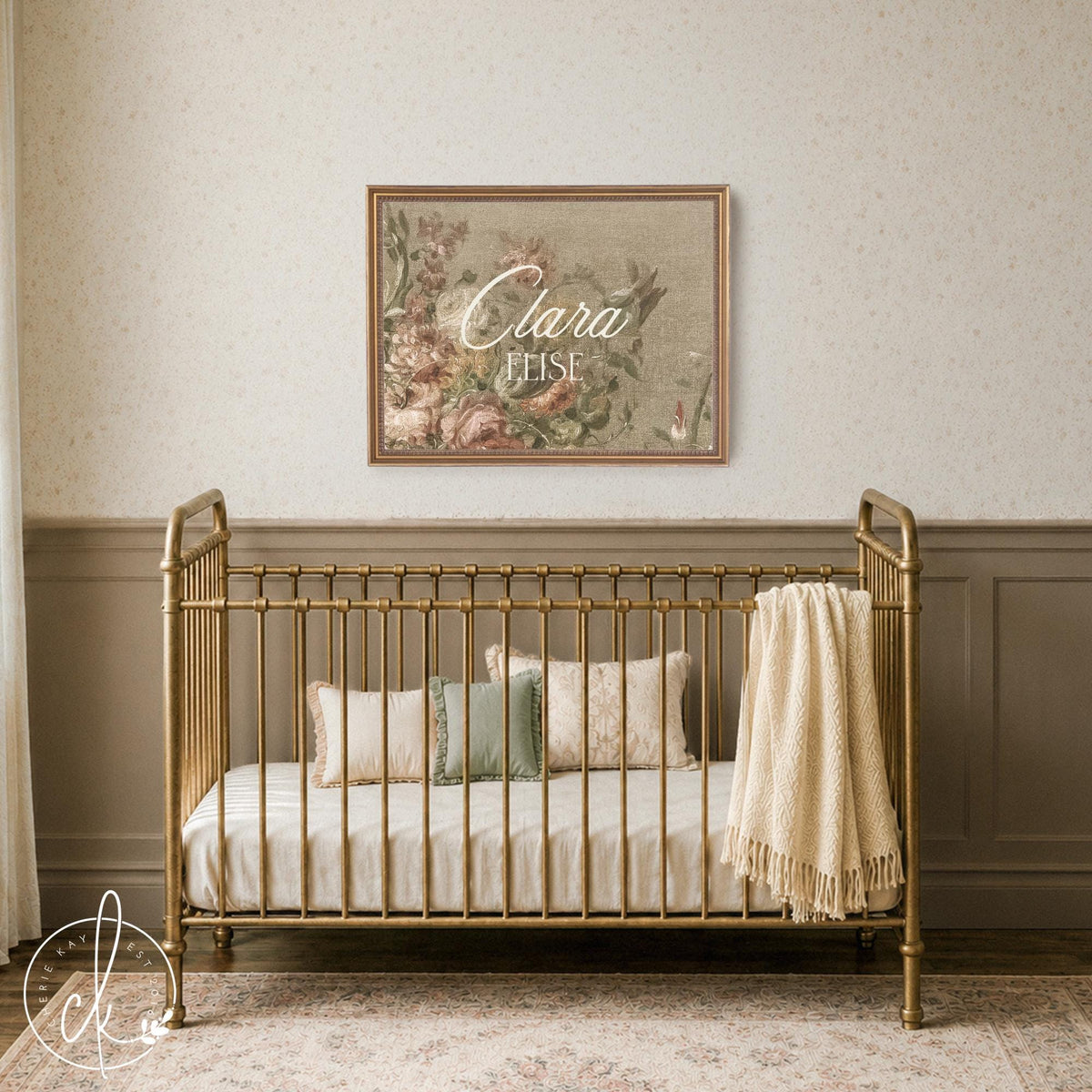 Personalized victorian nursery name sign with antique pink roses and gold frame shown above a brass crib