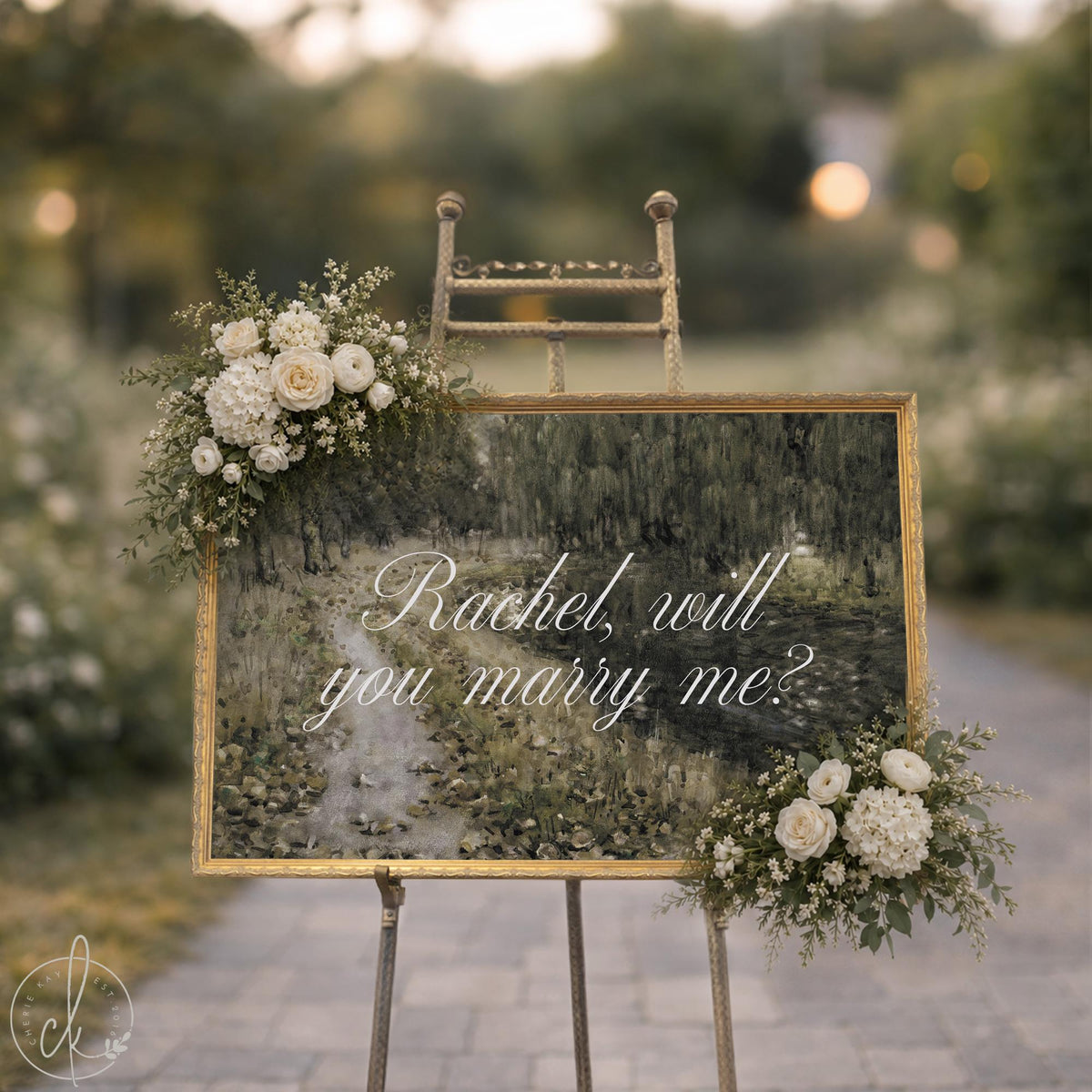 Personalized will you marry me sign with a green willow landscape and white script in an ornate gold frame on an easel