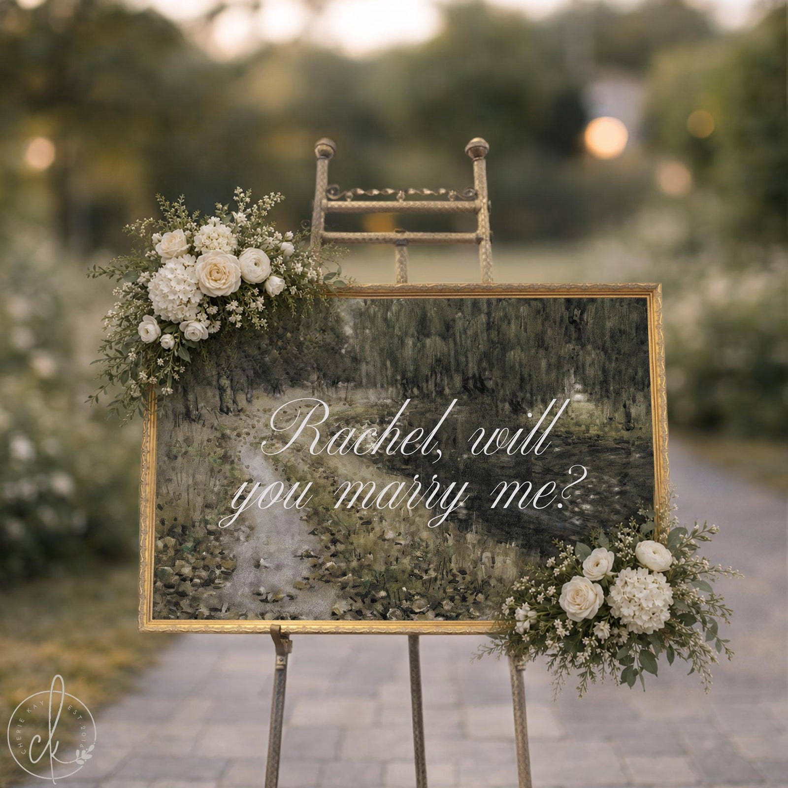 Personalized will you marry me sign with a green willow landscape and white script in an ornate gold frame on an easel