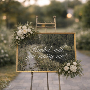 Personalized will you marry me sign with a green willow landscape and white script in an ornate gold frame on an easel
