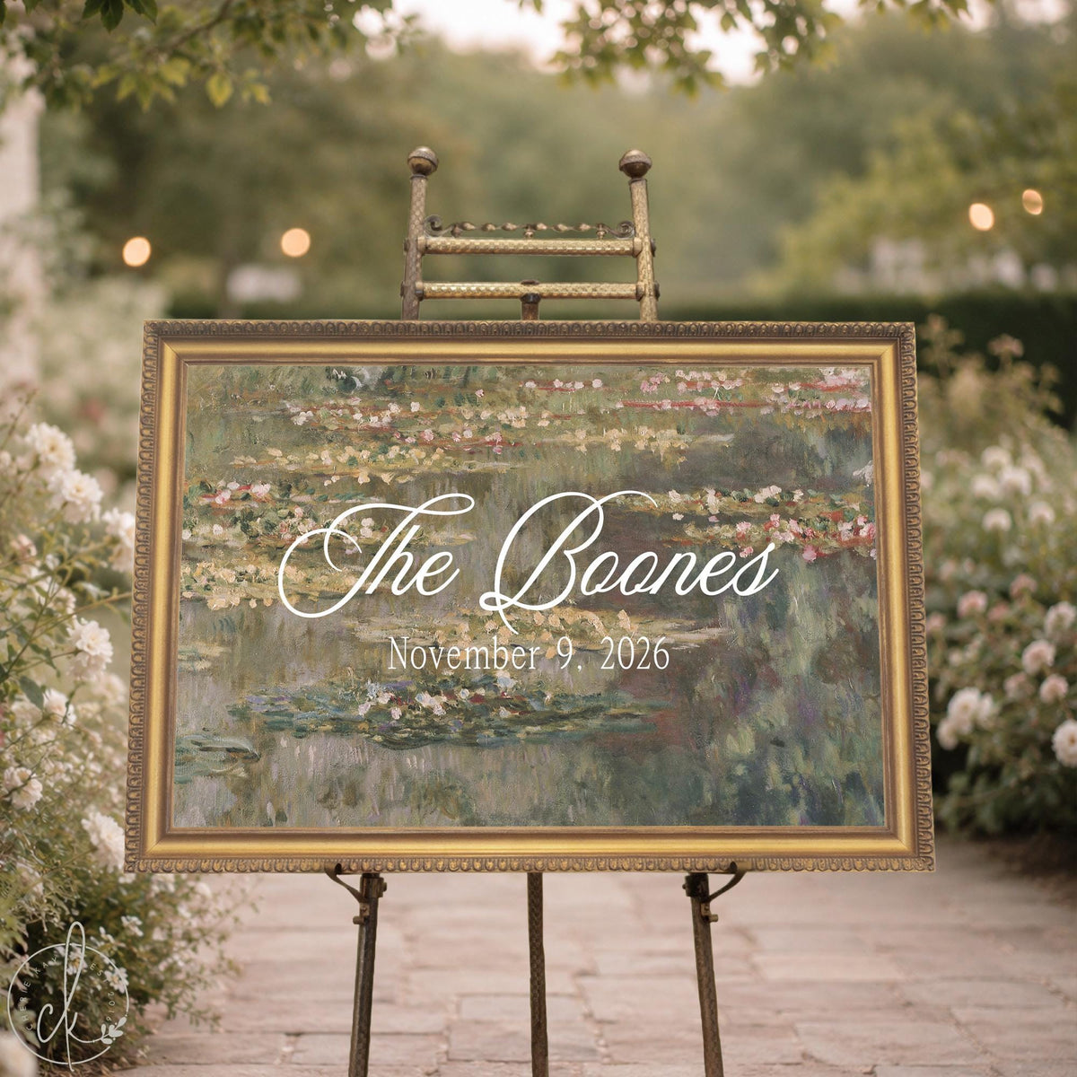 Personalized wedding easel sign with Monet water lilies canvas in an ornate gold frame showing last name and date.