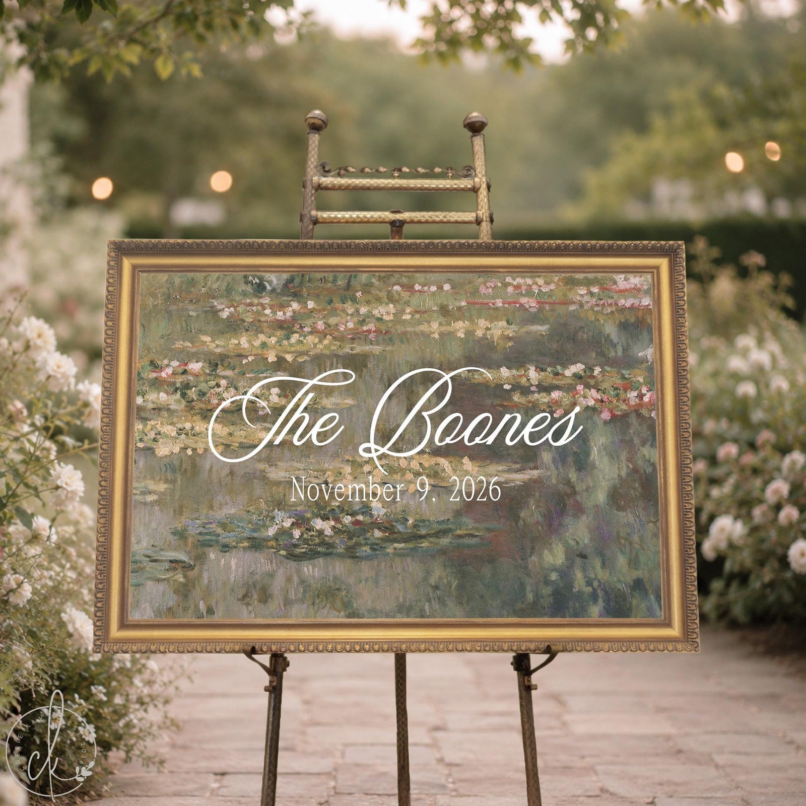 Personalized wedding easel sign with Monet water lilies canvas in an ornate gold frame showing last name and date.