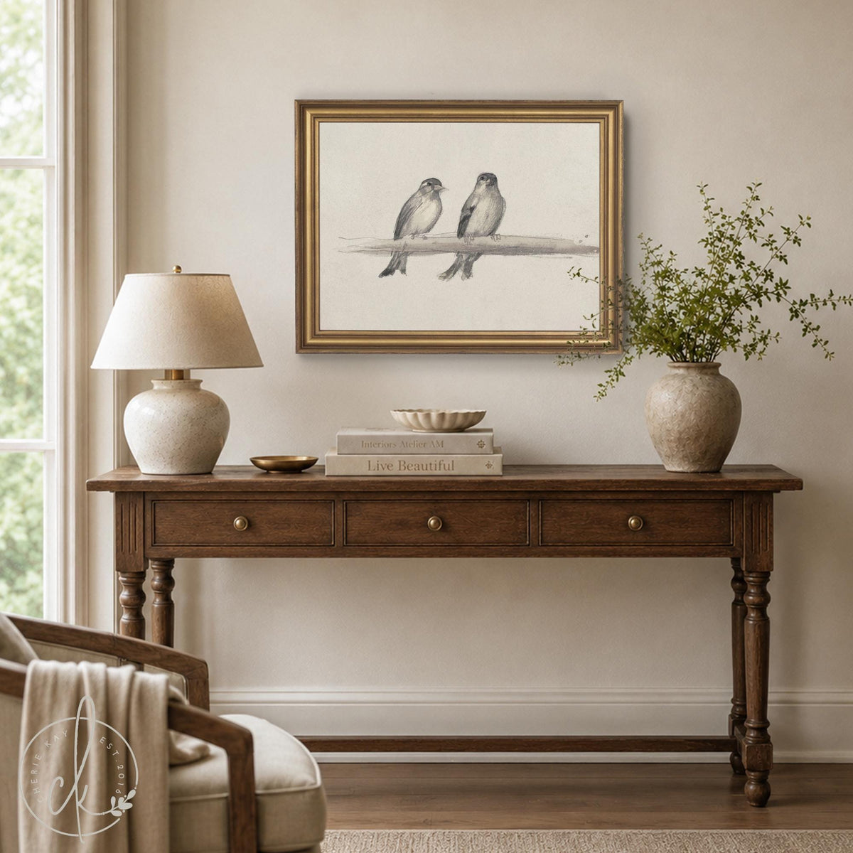 Framed bird art of two gray songbirds on a branch, printed in a soft sketch look in an ornate gold frame.