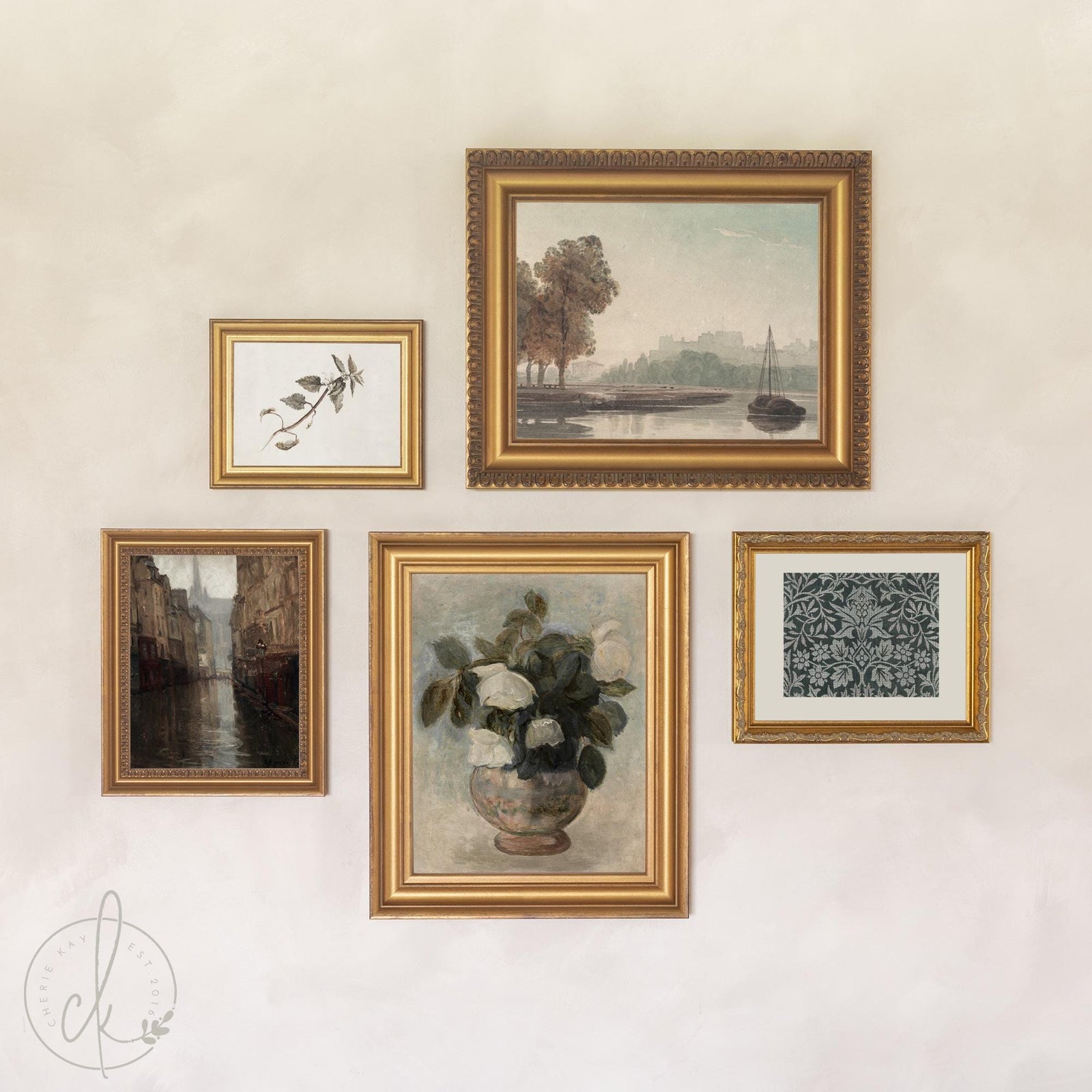 Curated gallery wall of 5 gold framed prints over a console table: river landscape, roses, rainy street scene