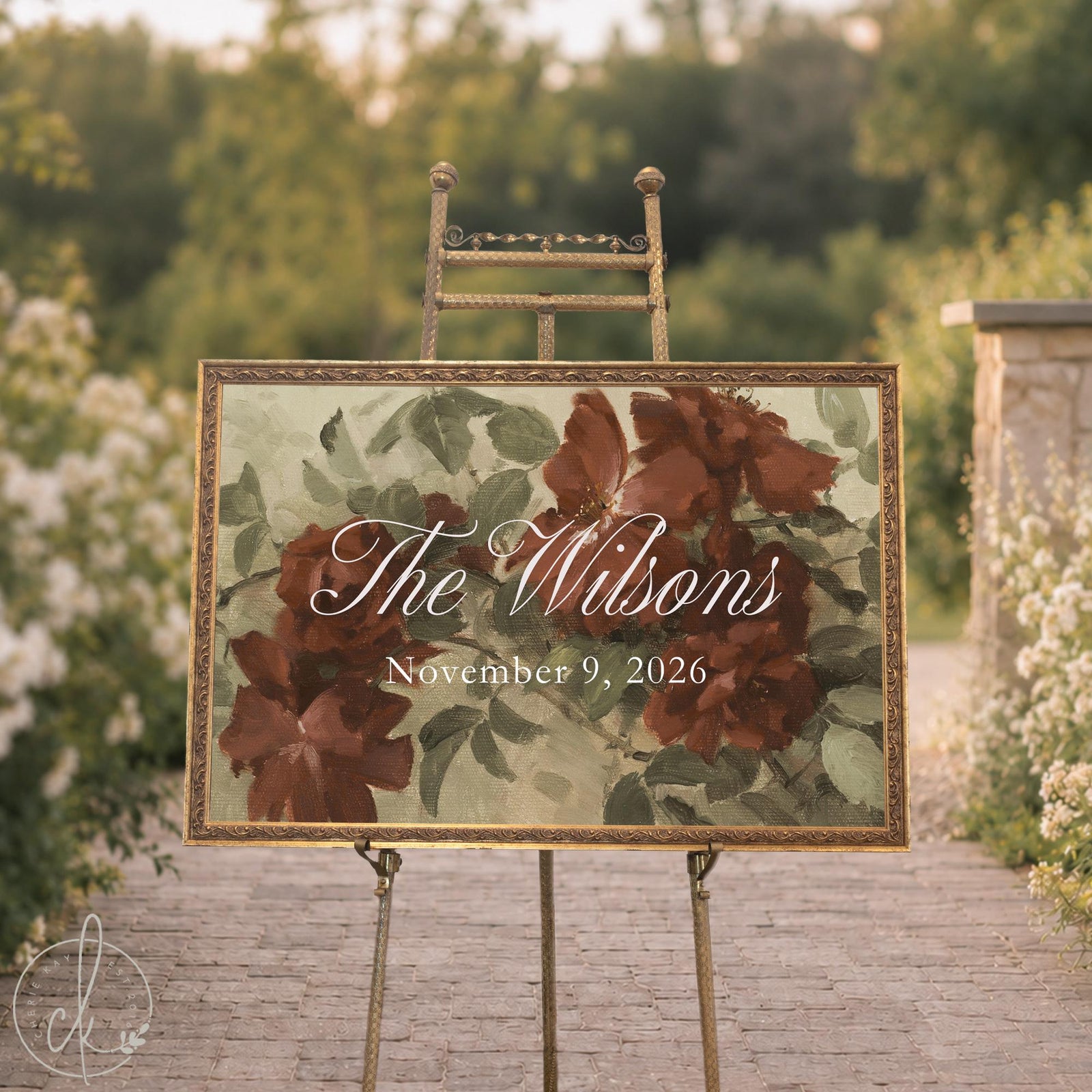 Personalized wedding decor on an easel, last name and date over wine roses on a sage green canvas