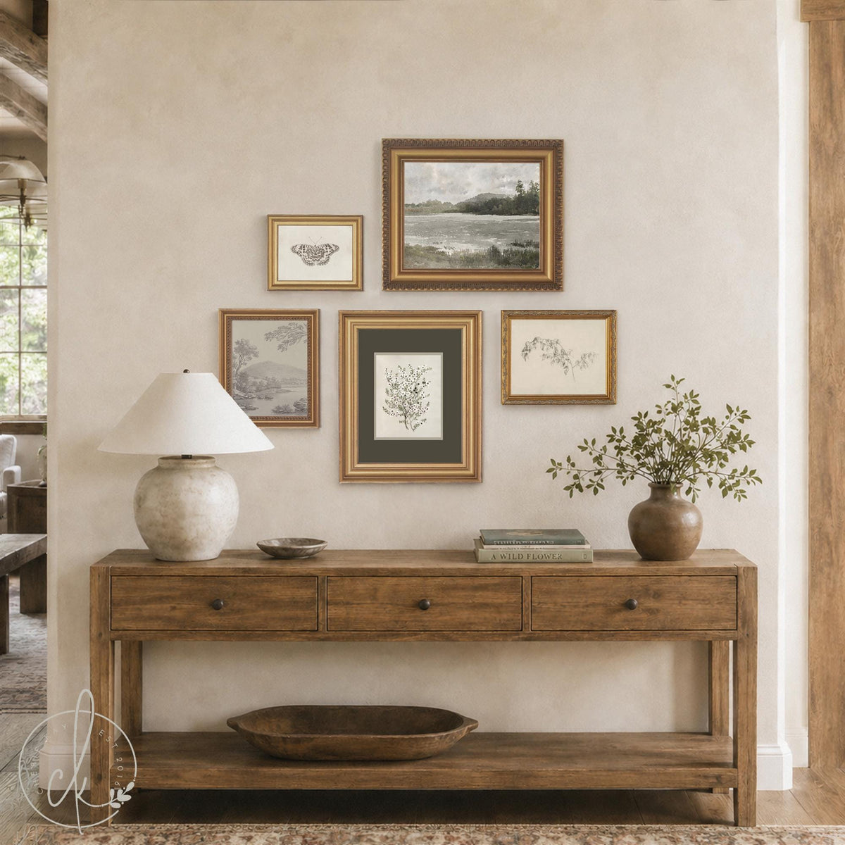 Gallery wall pictures set of 5 vintage prints in gold frames above a wood console table with a lamp and vase.