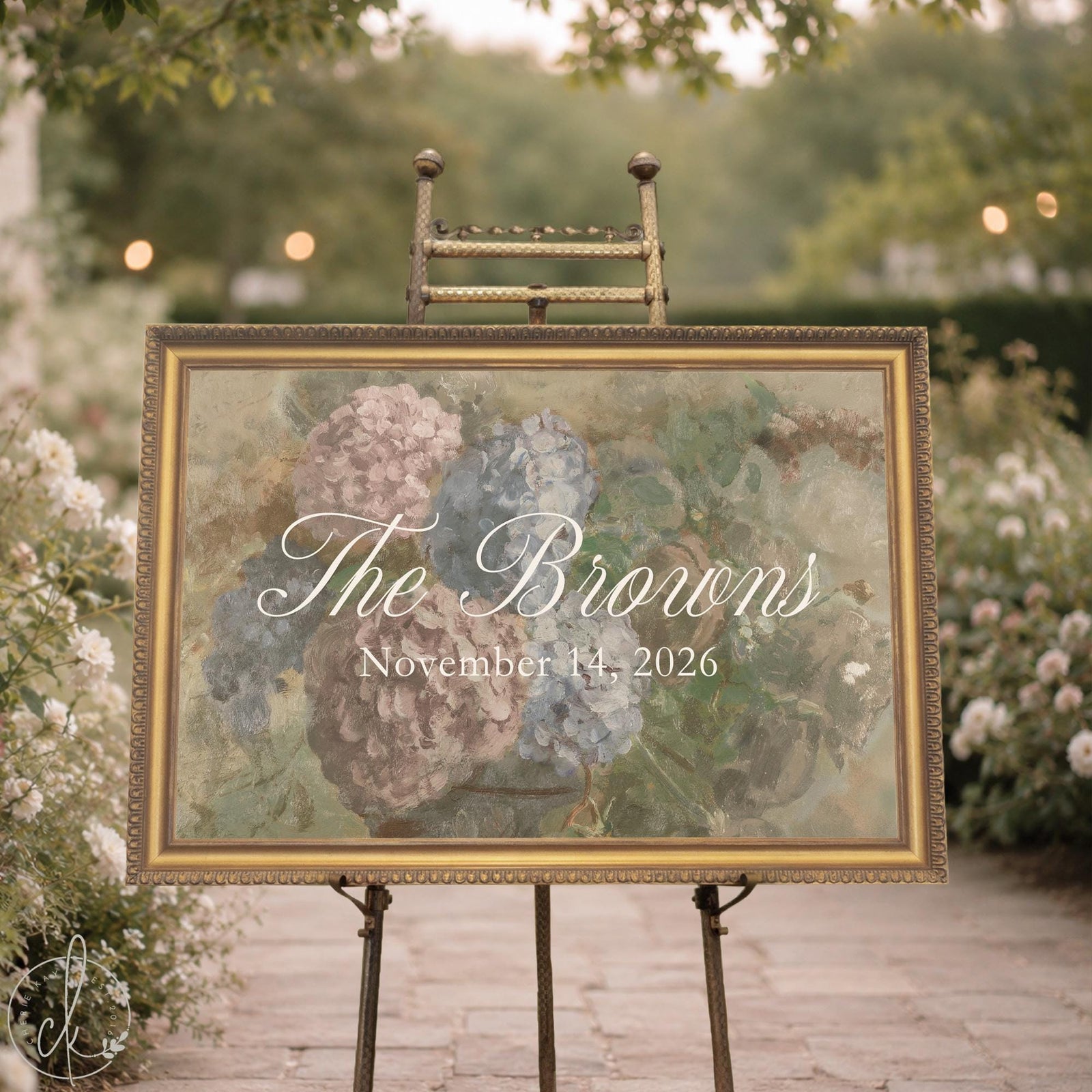 Garden wedding welcome sign on a gold easel, hydrangea canvas in an ornate gold frame with a last name and date