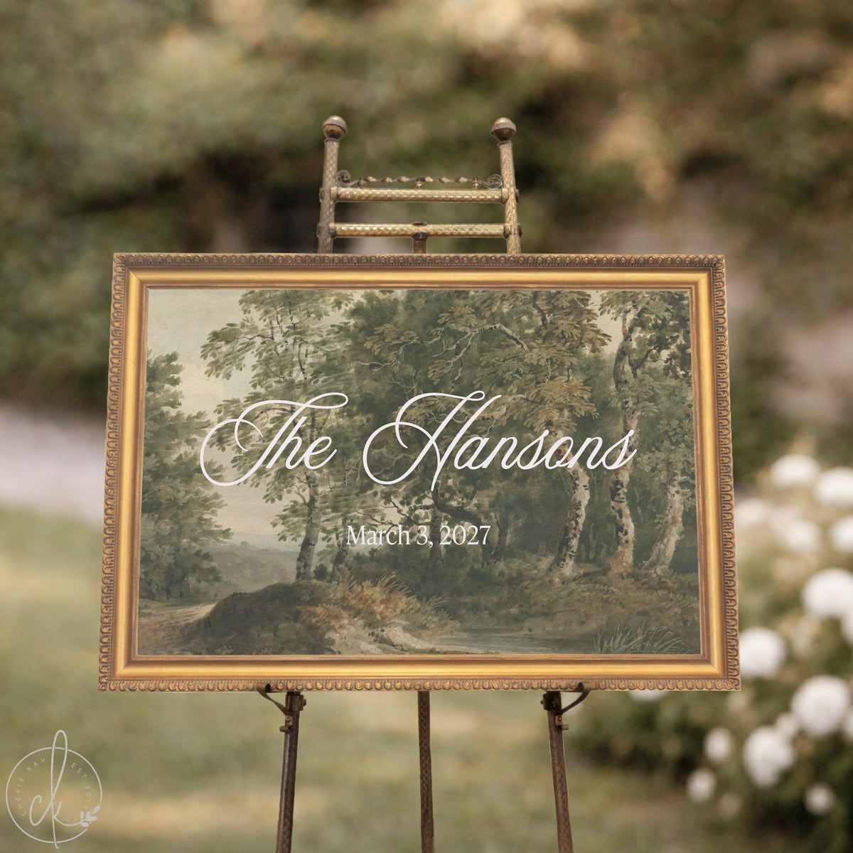 Family established sign with a last name and date on a vintage landscape canvas in an ornate gold frame, shown on an easel