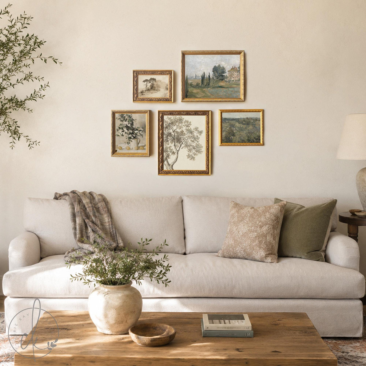 Picture collage wall of five gold framed vintage prints in mixed sizes, tree sketches and countryside, above a cream sofa