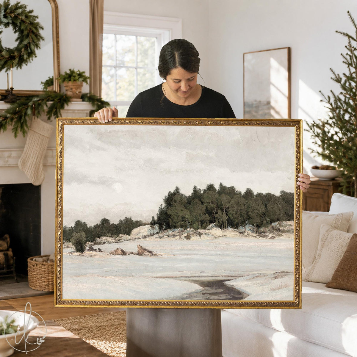 Mantel art of a snowy winter field and evergreen trees in an ornate gold frame, held up in a living room