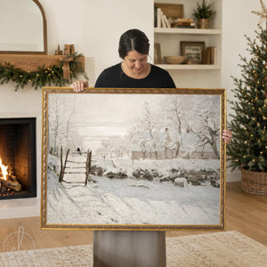 Monet The Magpie print in an ornate gold frame, snowy farm with a magpie on a gate, shown in a Christmas living room