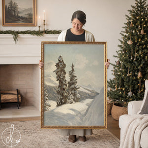 Vintage Christmas print of snowy alpine evergreens on a mountain slope in an ornate gold frame, held up in a living room