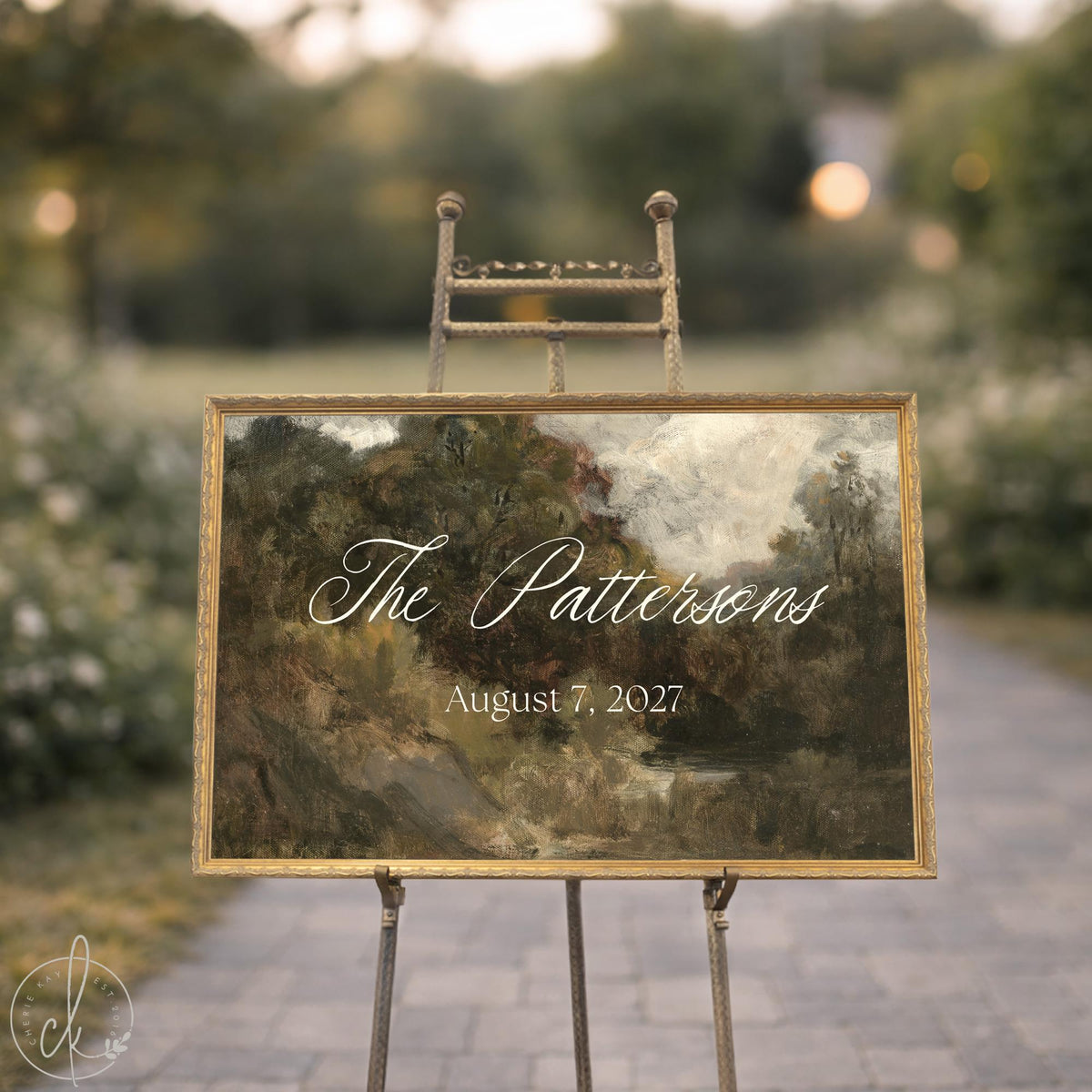 Personalized housewarming gift sign with a last name in white script over a landscape painting in an ornate gold frame