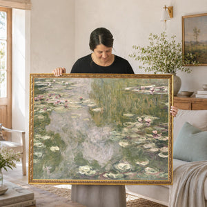 Monet lily pads print in an ornate gold frame, pink water lilies on a soft green pond, held up in a living room
