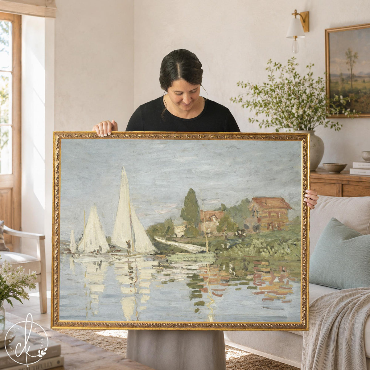 Framed sailboat art, Monet’s Regattas at Argenteuil in an ornate gold frame, white sails on a river, held up in a living room