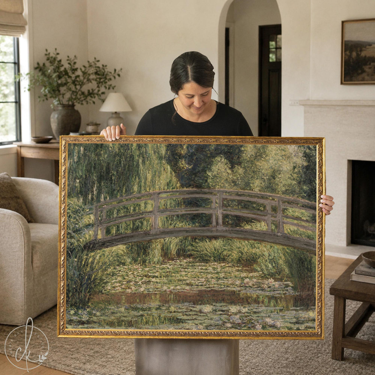 Monet bridge painting in an ornate gold frame, footbridge over a water lily pond, held up in a living room