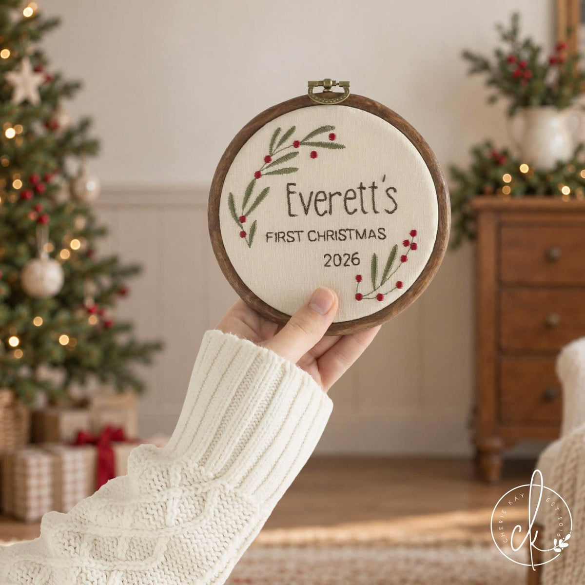 Personalized Christmas ornament hoop with a baby’s name, First Christmas and the year, framed by red berry sprigs