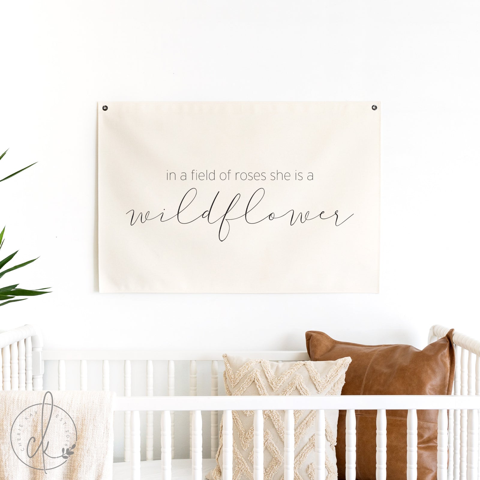 Decorative wall hanging with text over a crib