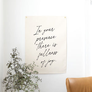 Poster with motivational quote on a wall with a plant and chair in the foreground
