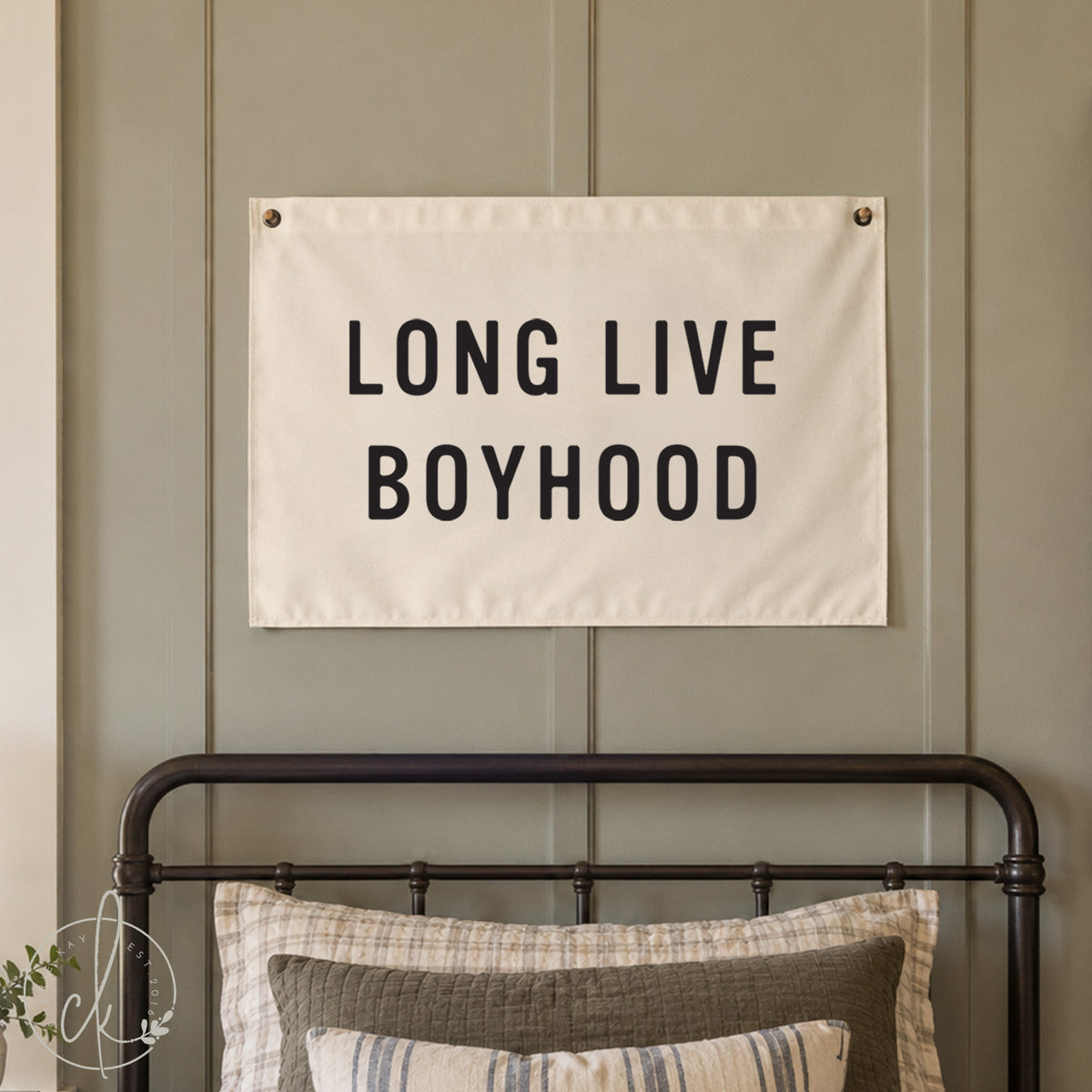 A rectangular white fabric wall banner featuring the black text LONG LIVE BOYHOOD in a bold sans-serif font. The banner is mounted with metal grommets in the top corners, displaying a clean, minimalist design for wall decor.