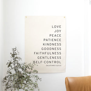 Poster with motivational text on a wall with a plant and chair in the foreground