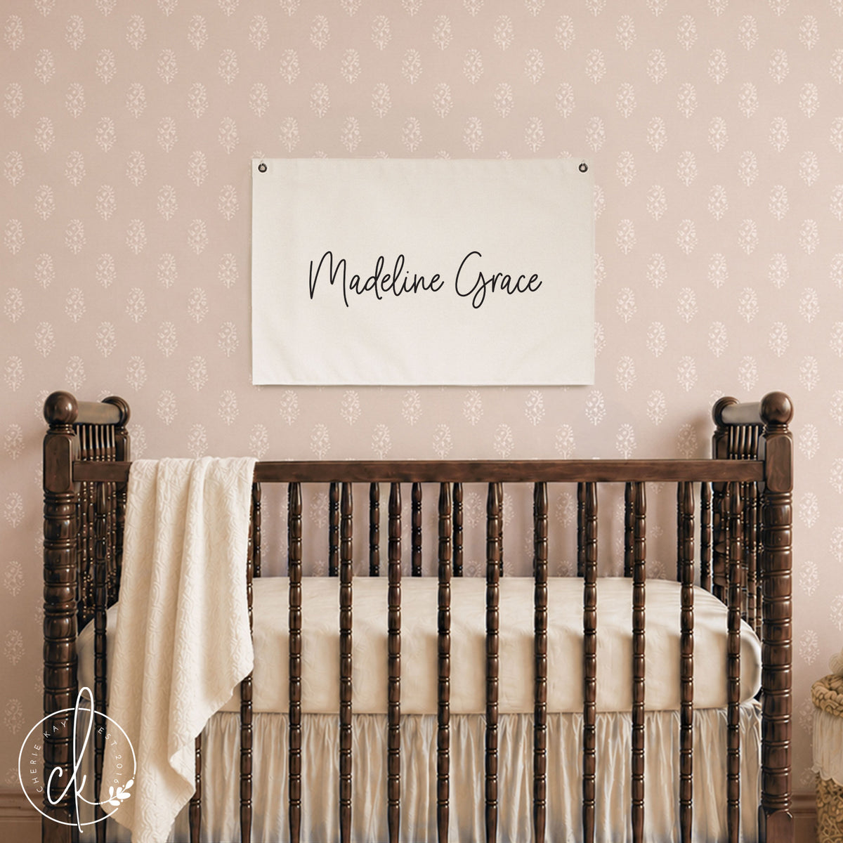 Nursery name banner canvas flag with baby girl's name in cursive script on cream canvas with grommets