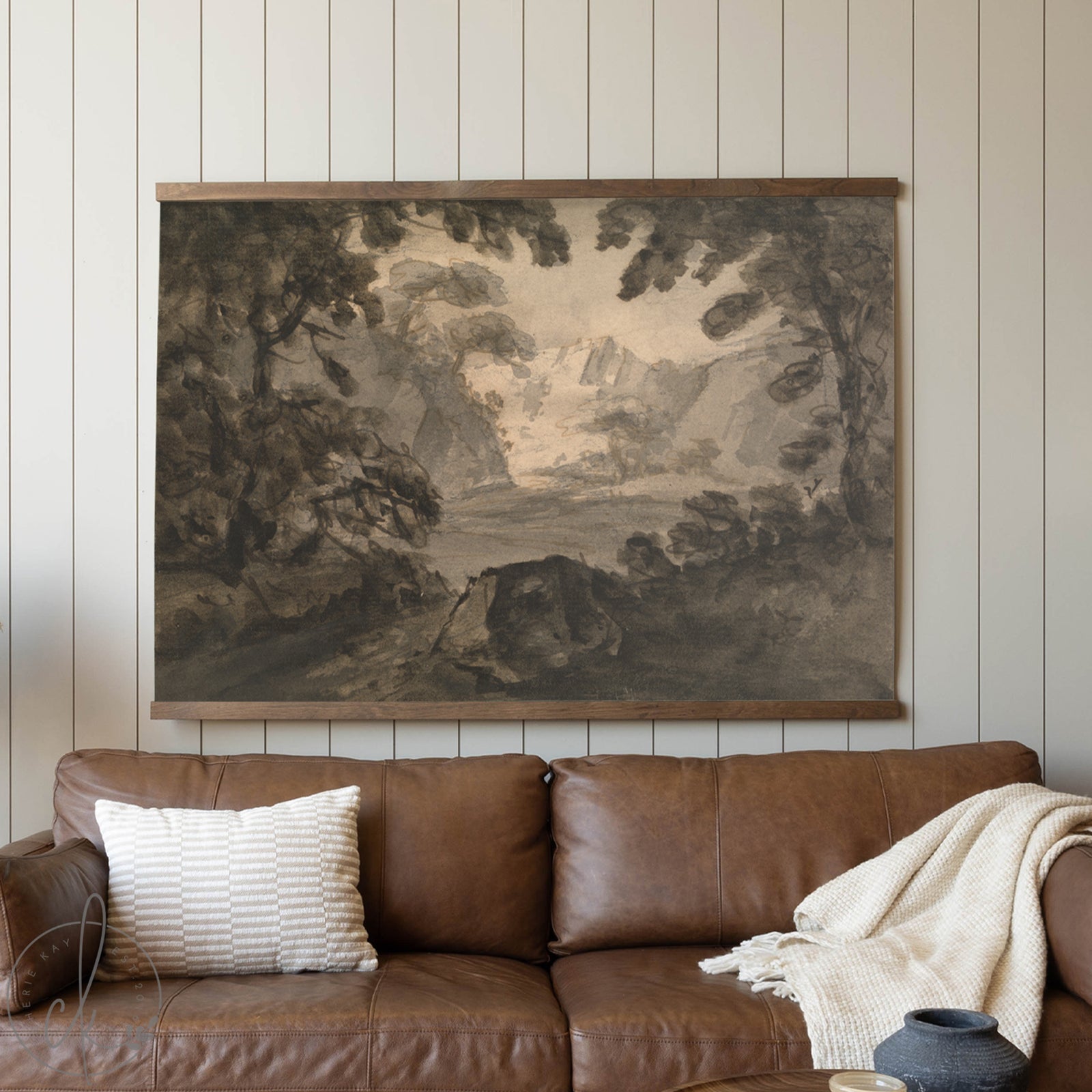 Brown leather sofa with a decorative tapestry above it in a room with wooden paneling.