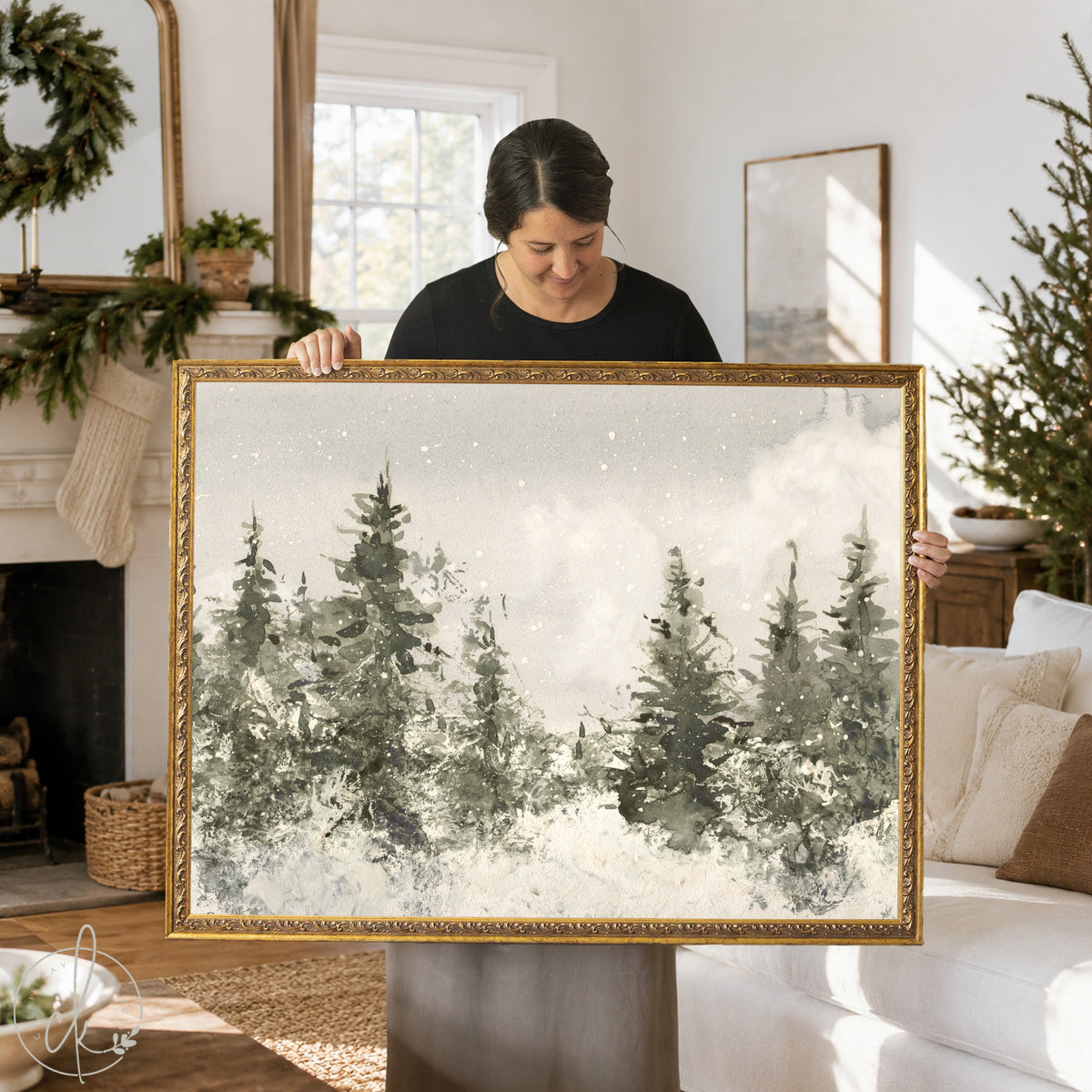 A rectangular landscape painting in a gold ornate frame featuring a watercolor-style forest scene with dark green and gray pine trees against a soft white snowy background with subtle white speckles representing falling snow.