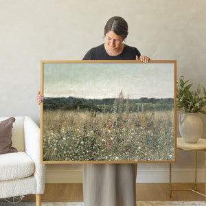 Framed wildflower meadow landscape wall art featuring blue flowers and golden grasses in natural wood frame for home decor