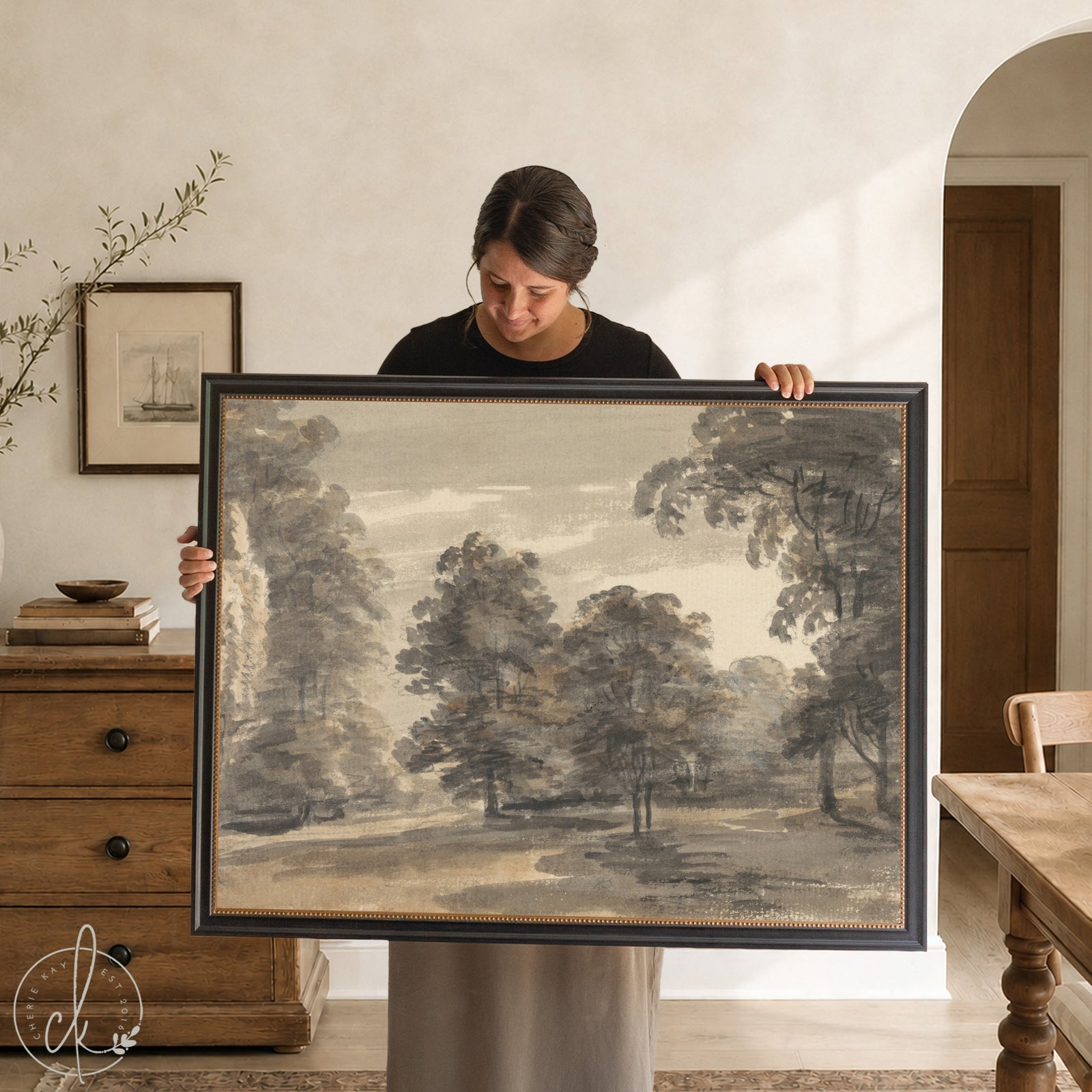 Moody landscape wall art in a black frame with gold beaded liner, a charcoal woodland tree scene.