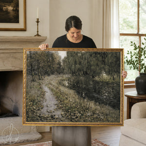 Framed landscape painting with river and trees in vintage gold frame wall art style.