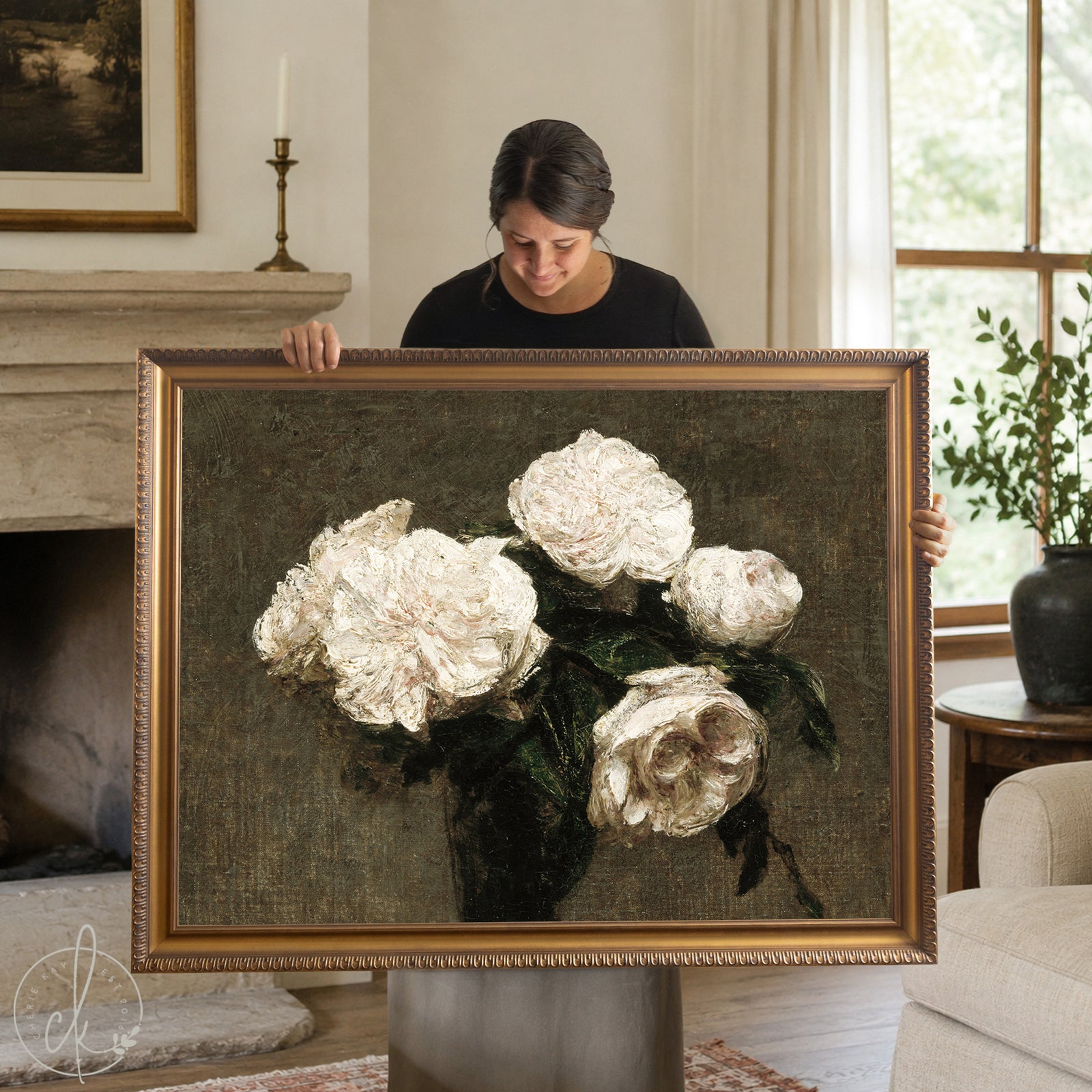 Moody floral wall art with white roses in a gold wood frame, hung above a cream sofa in a living room.