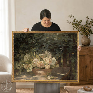 Woman holding Antique botanical art print with flowers in gold frame. 