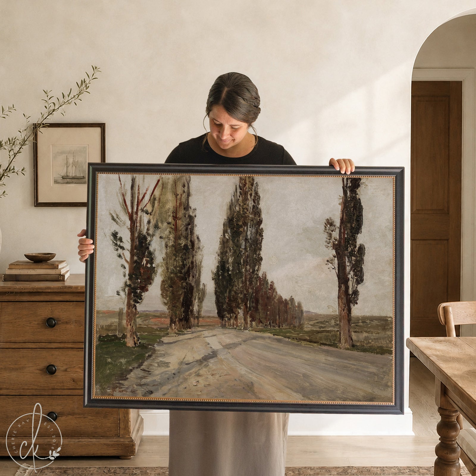 European landscape art print featuring a gold framed vintage tree-lined road painting in muted greens and browns