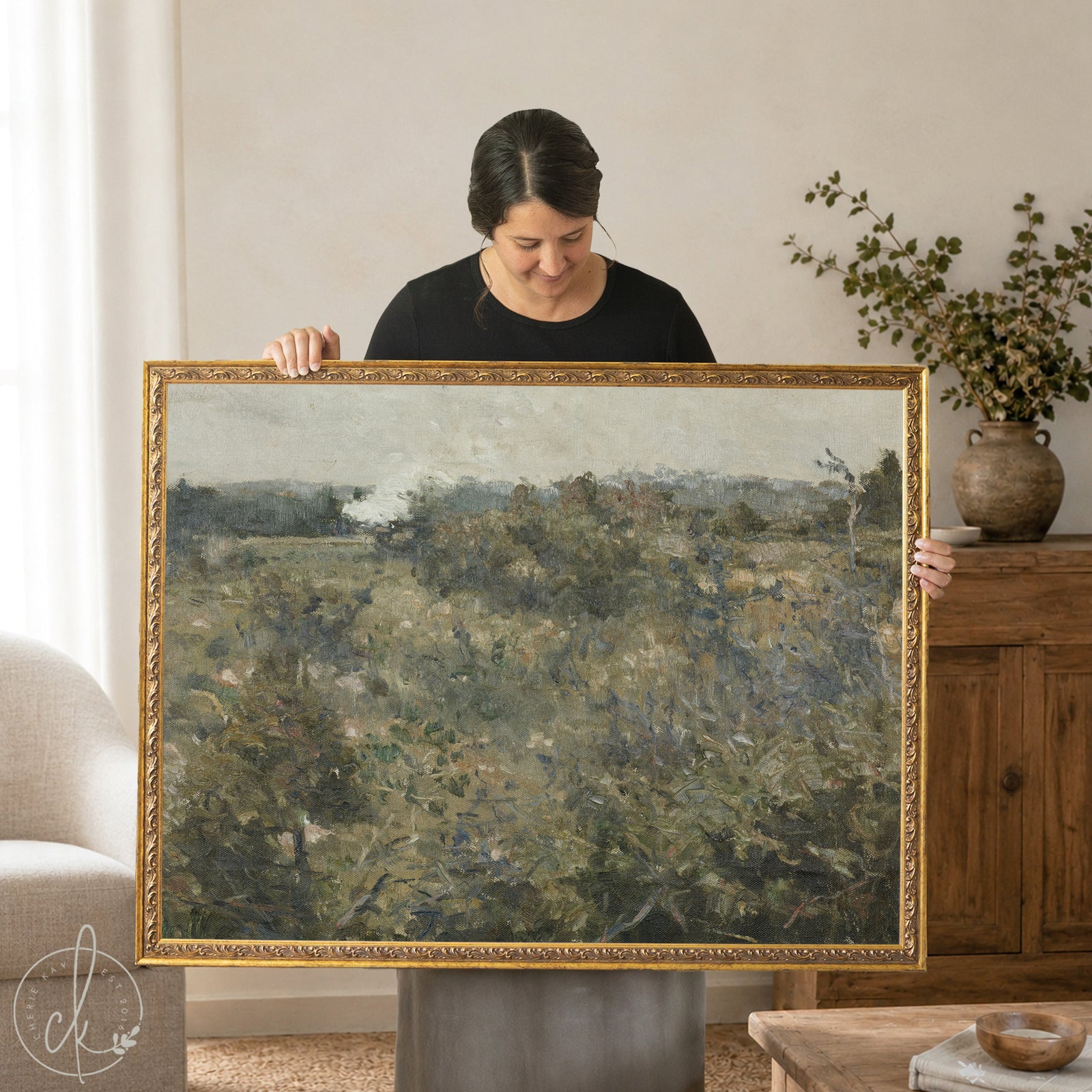 A large rectangular landscape painting in a ornate gold frame The artwork depicts a muted, earthy scene of dense green and brown foliage under a cloudy, overcast sky, rendered in a textured, painterly style.
